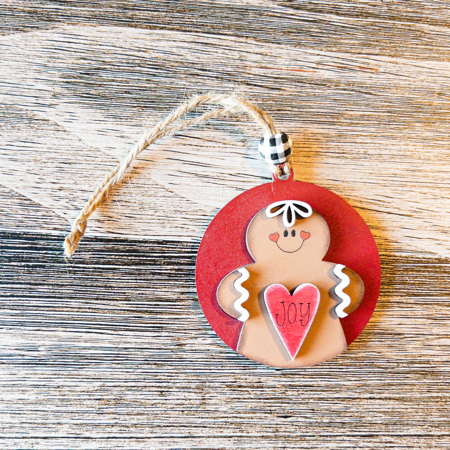 hand-painted round gingerbread ornament holding a heart - Millie & Co.