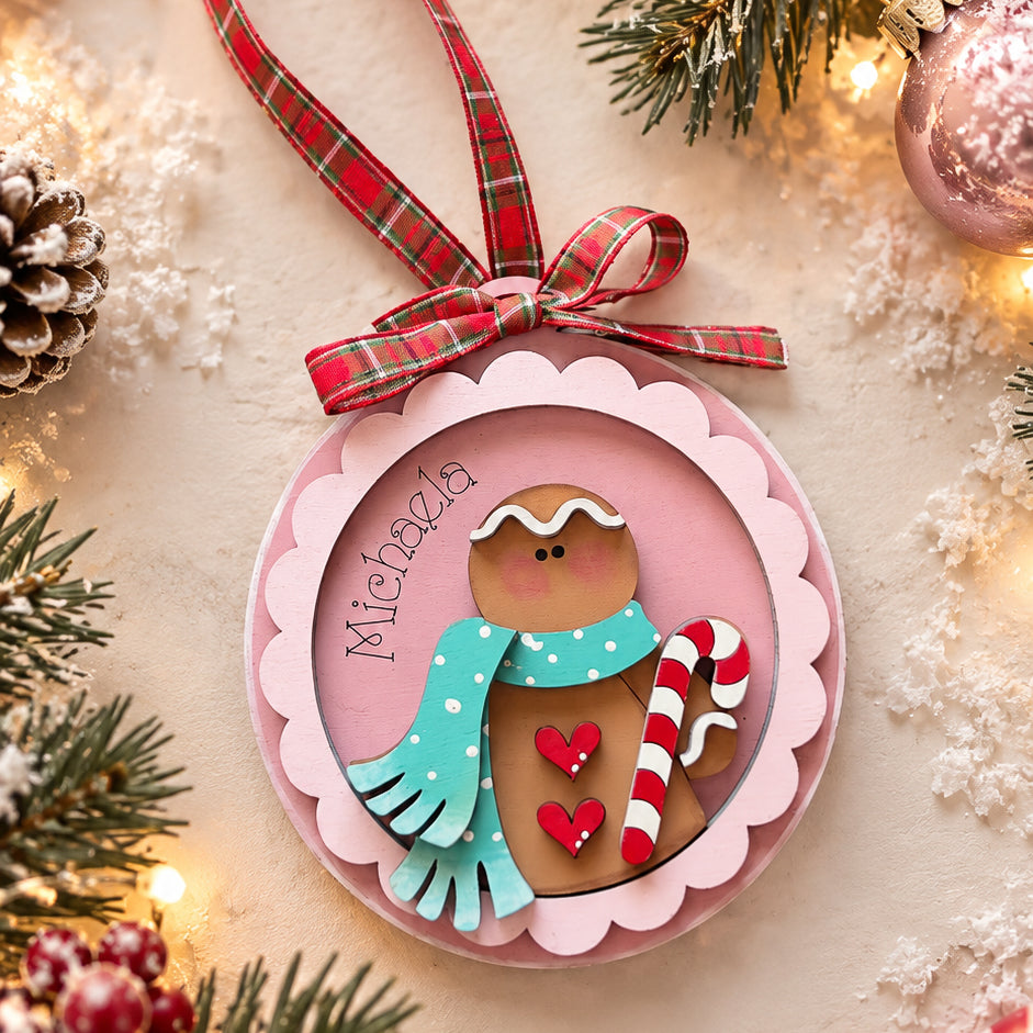 Personalized gingerbread ornament with name engraved in script, pink scalloped frame, teal scarf and candy cane, hand-painted by Millie & Co.