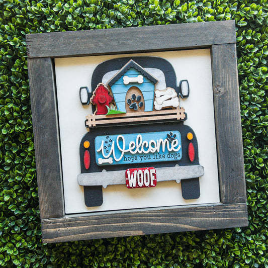 Dog lover porch decor tile of a black truck with a dog house, Welcome sign, and Woof license plate | Millie & Co.