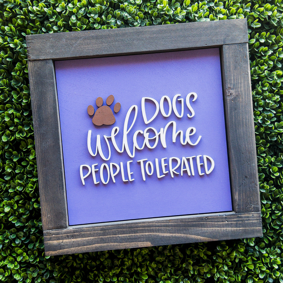 Interchangeable porch decor tile reading Dogs Welcome, People Tolerated on purple with a paw print | Millie & Co.