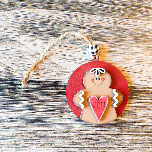 hand-painted round gingerbread ornament holding a heart - Millie & Co.