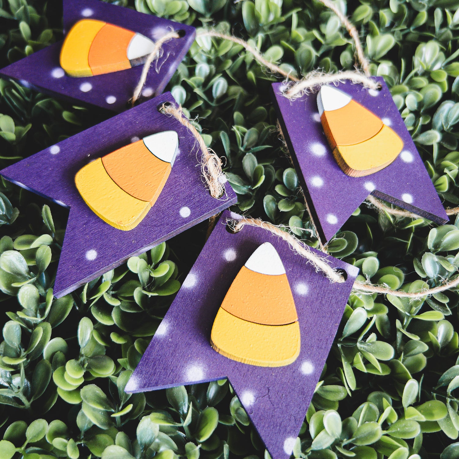 Halloween porch decor ladder wrap with hand-painted candy corn pennants on jute twine | Millie & Co.