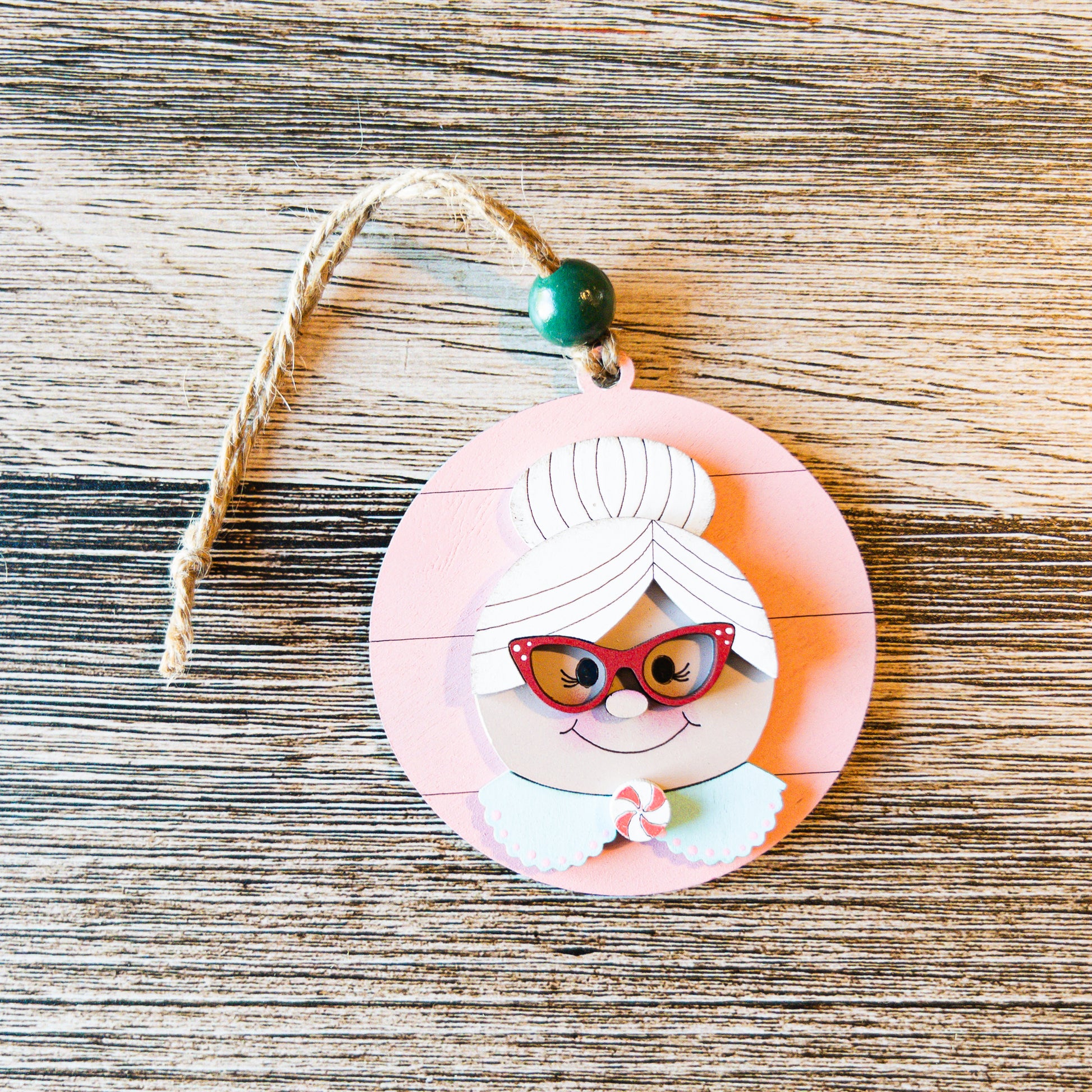 hand-painted Mrs. Claus ornament with peppermint and glasses detail - Millie & Co.