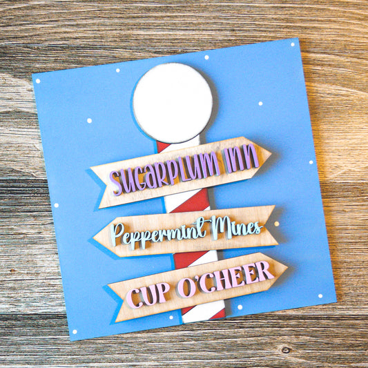 hand-painted interchangeable Christmas tile featuring a whimsical North Pole signpost - Millie & Co.