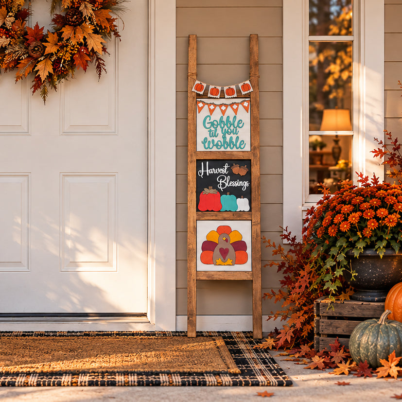 Pumpkin fall porch decor ladder wrap on an interchangeable porch ladder with Gobble Til You Wobble, Harvest Blessings, and turkey Thanksgiving tiles by a front door | Millie & Co.