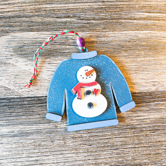 hand-painted blue sweater ornament with snowman and red scarf - Millie & Co.