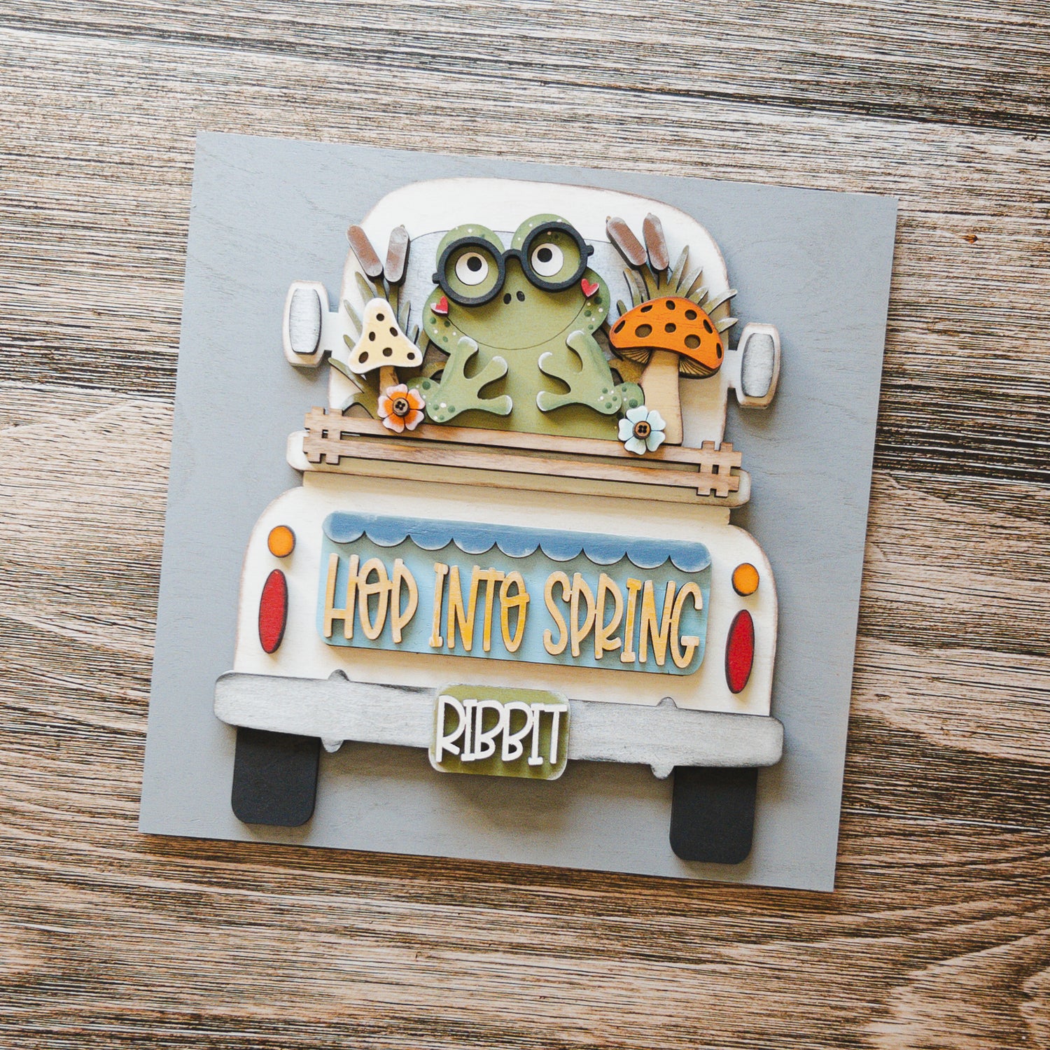 Seasonal porch decor tile of a vintage frog truck in soft spring greens — Millie & Co.