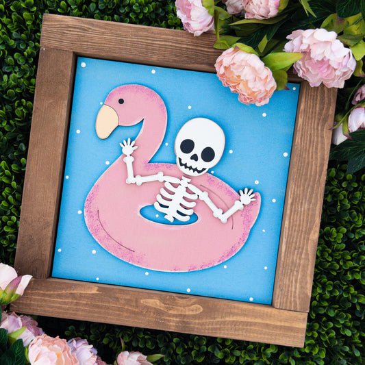 Summerween porch decor tile with a skeleton floating in a pink flamingo pool float, Millie & Co.