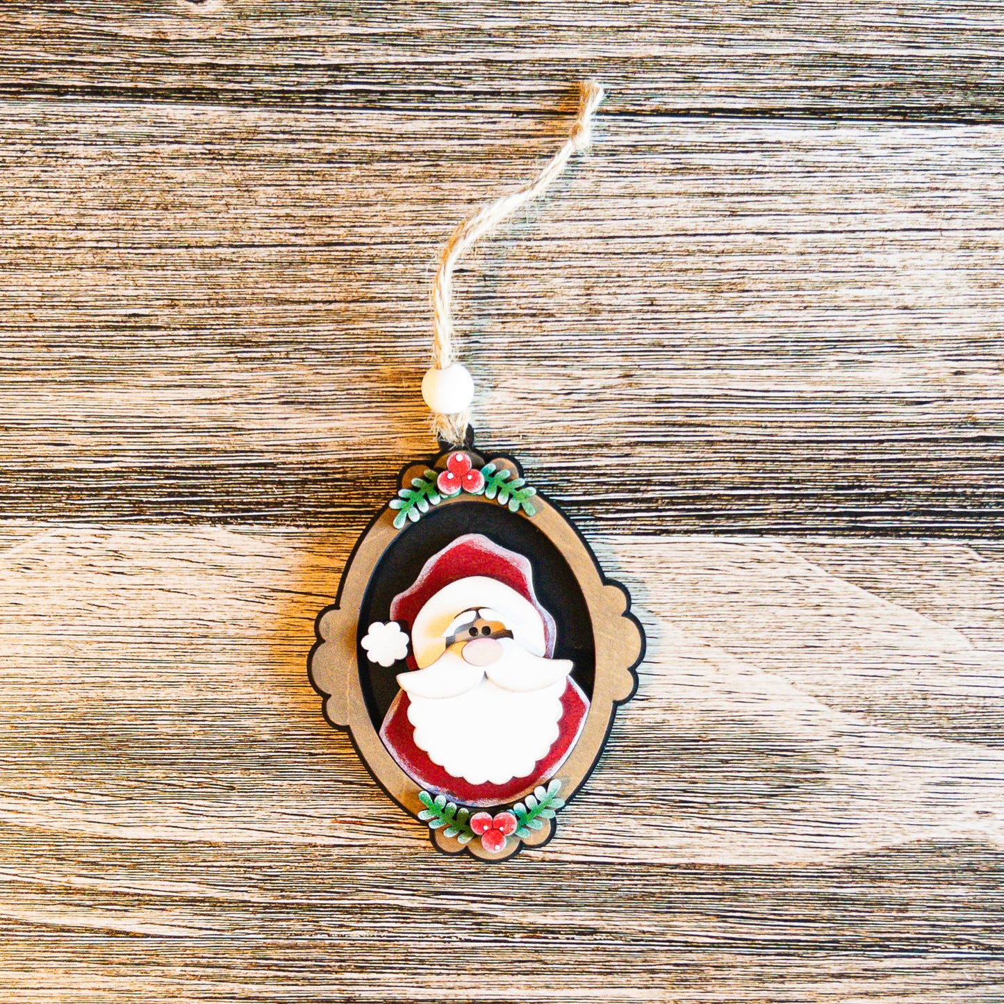 hand-painted vintage cameo Santa ornament with evergreen accents - Millie & Co.